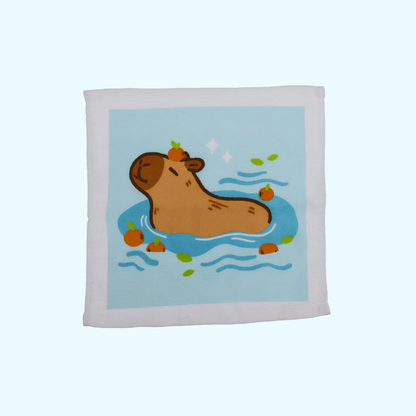 Capybara - Magisches Baumwollhandtuch 30x30cm - Capybara mit blauem Hintergrund - SNACKS24.AT