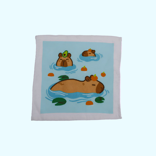 Capybara - Magisches Baumwollhandtuch 30x30cm - Drei Capybara mit blauem Hintergrund - SNACKS24.AT